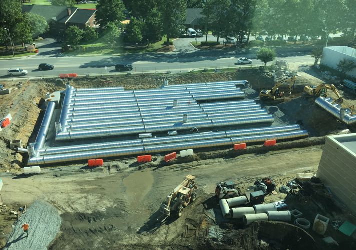 Installation of a Contech corrugated metal pipe stormwater detention system.