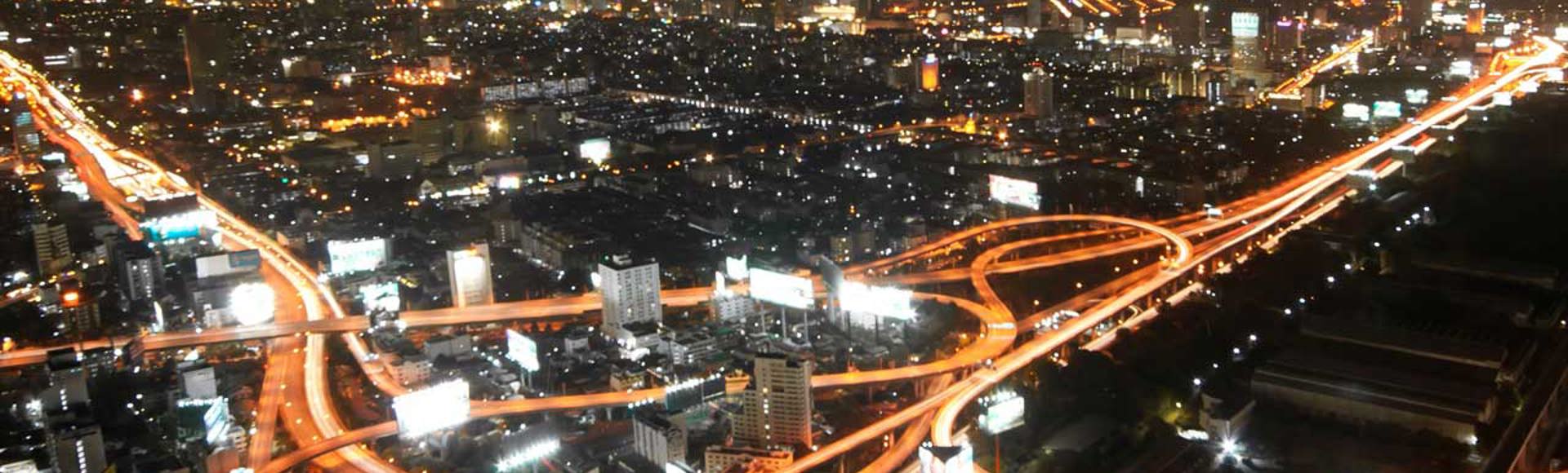 A highway interchange shown from above at night. 