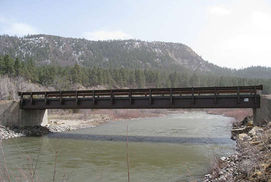 A Big R rolled girder bridge over a river.