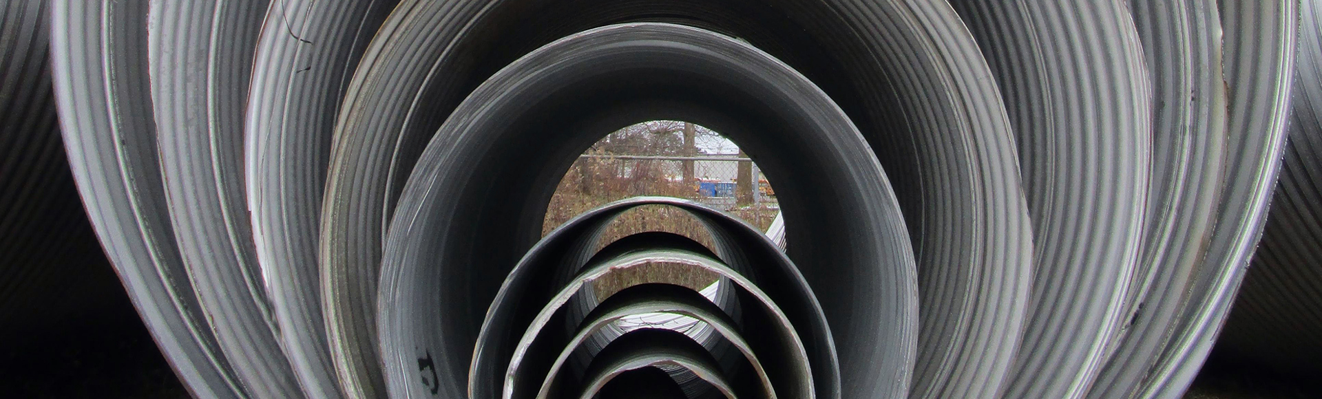 Several corrugated metal pipes nested inside each other. 